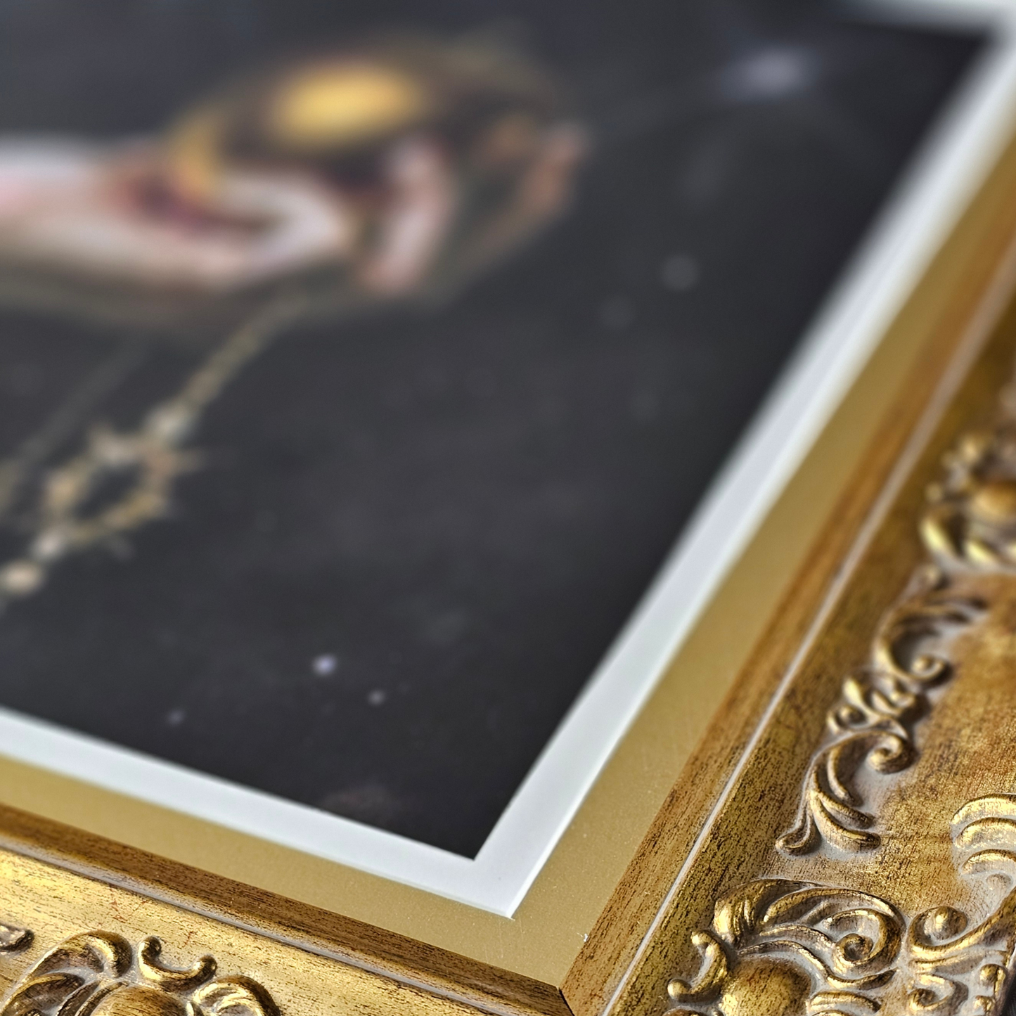 Close-up of a gold-framed painting with intricate details