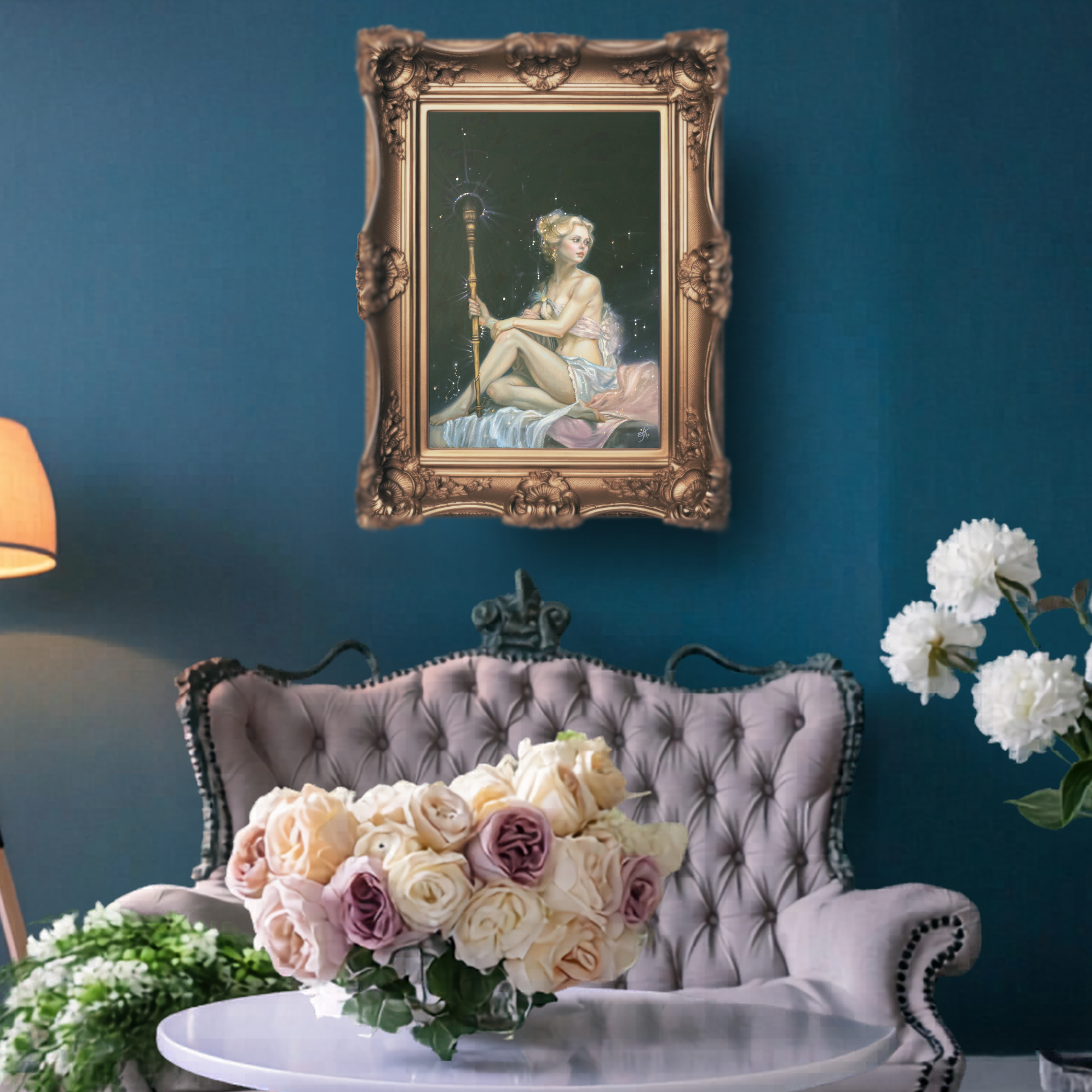 Decorative interior with a framed painting, flowers, and a gray sofa against a blue wall.