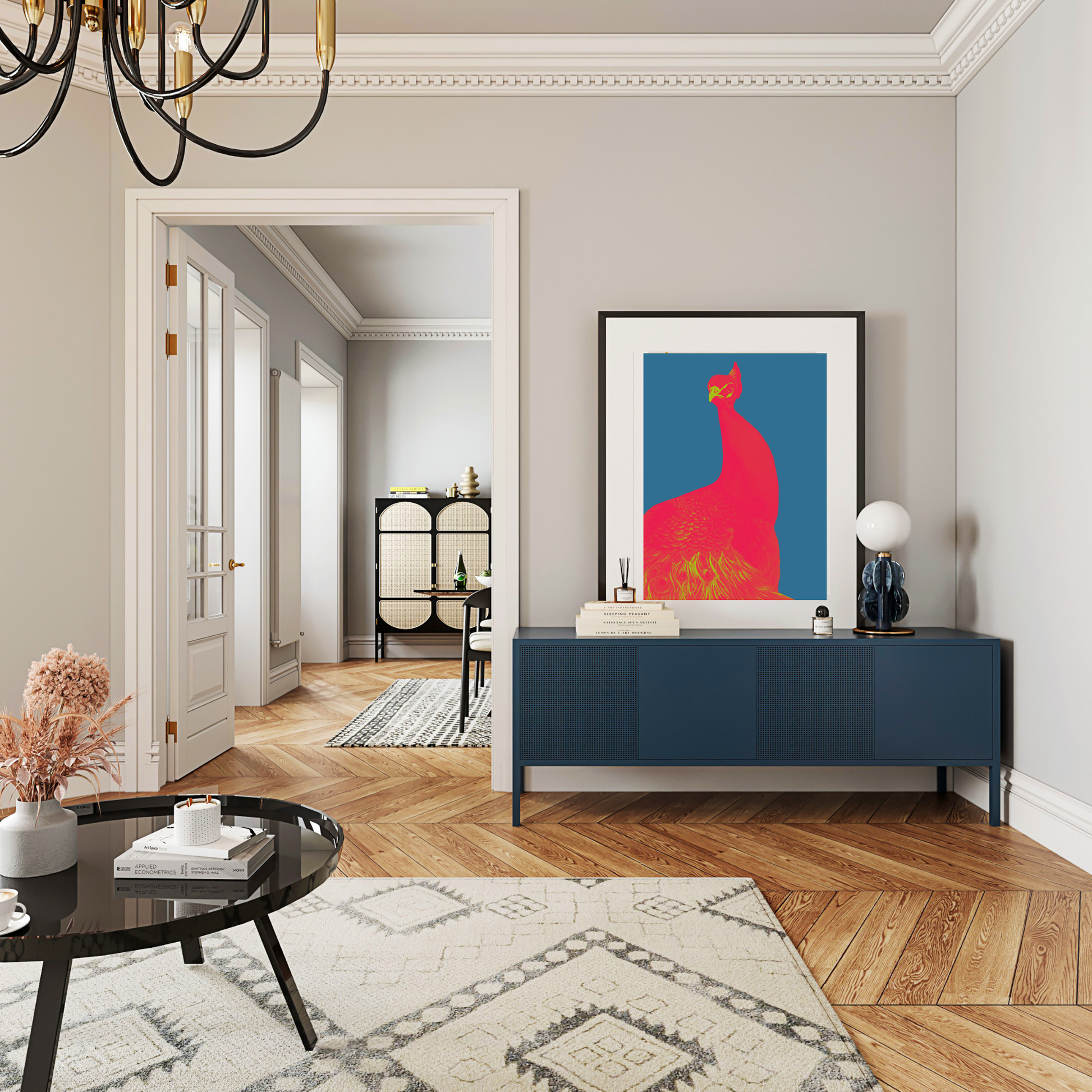 A framed abstract art print featuring a red peacock on a blue background, displayed on a dark blue console table in a modern, stylishly decorated living room with wood floors and a patterned rug.