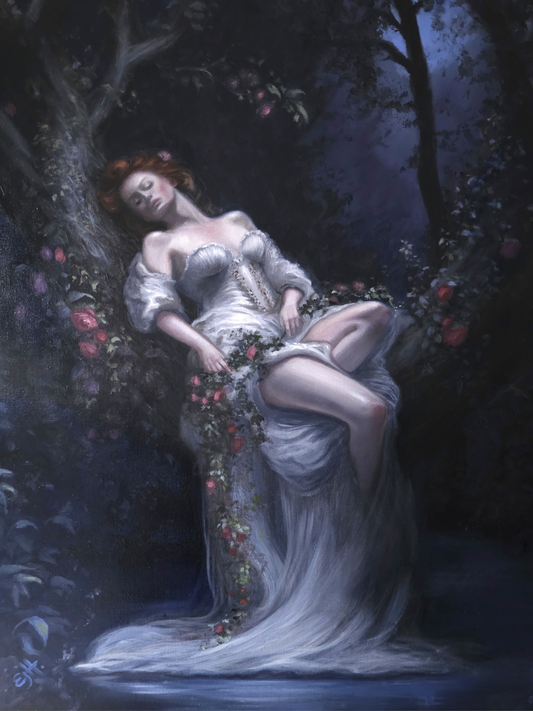 Woman in a white dress sitting in a garden with flowers and trees